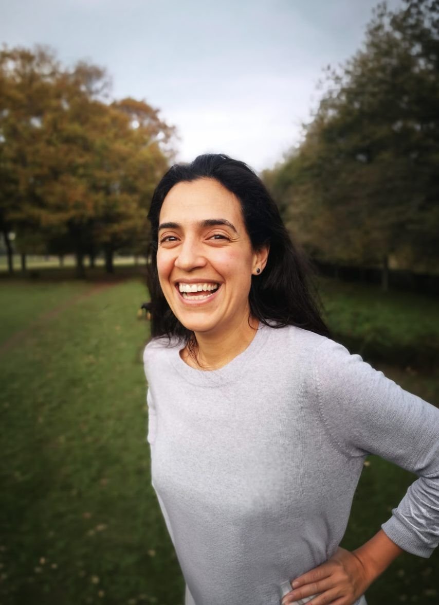Paula McMeekin smiling outdoors in a park in autumn